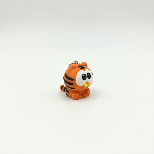 3D printed orange tiger cat keyring figurine on white background