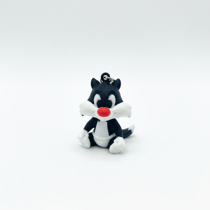 3D printed black and white cat keyring figurine on white background